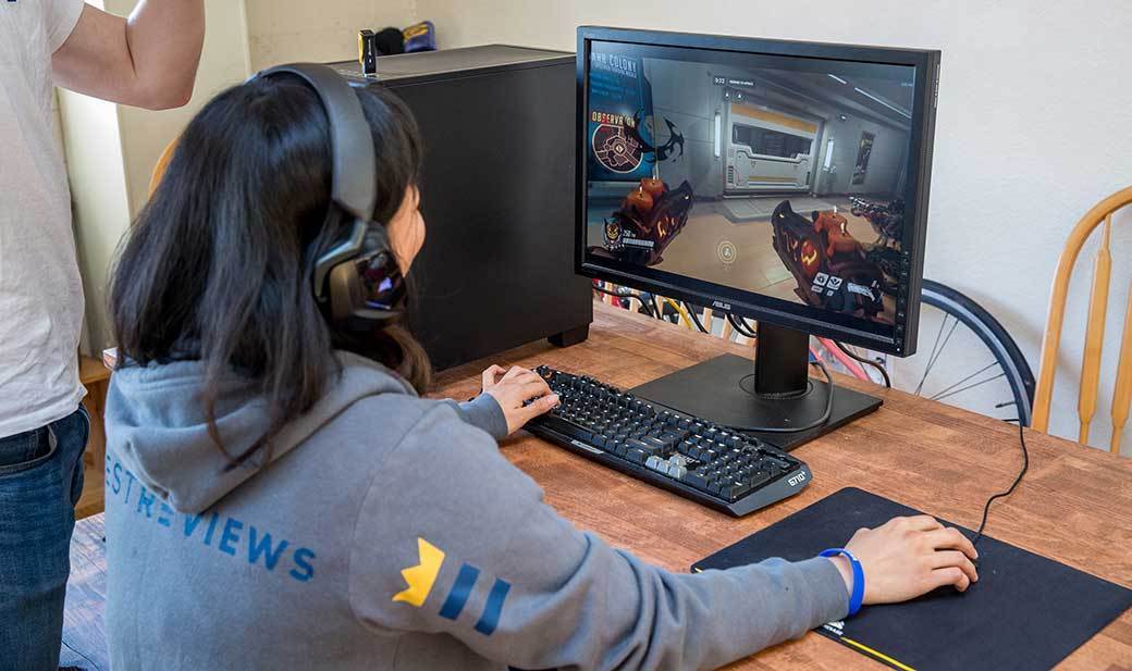 Person playing a video game at a desk