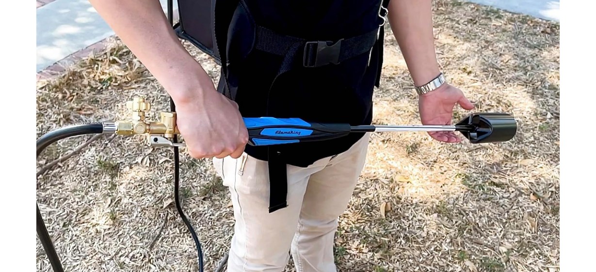 Person holding Flame King Heavy-Duty Propane Weed Torch