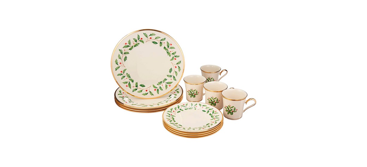 Beige cups and plates with gold trim and images of holly leaves on them