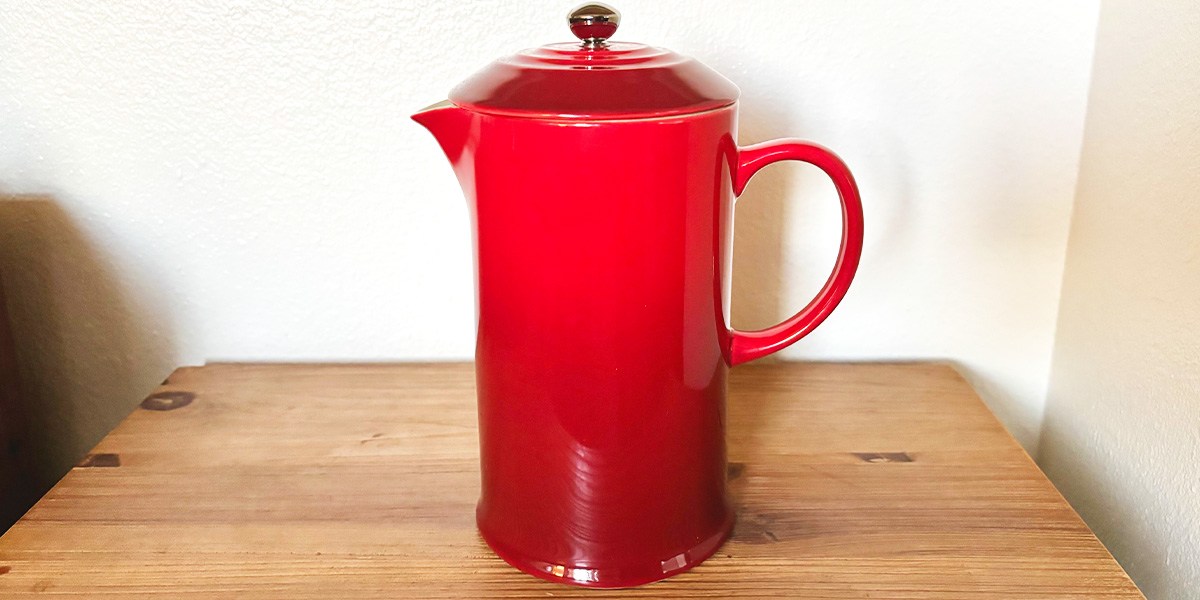 Red French Press on table
