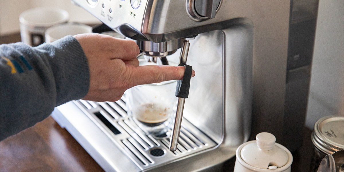 Person making espresso with espresso machine