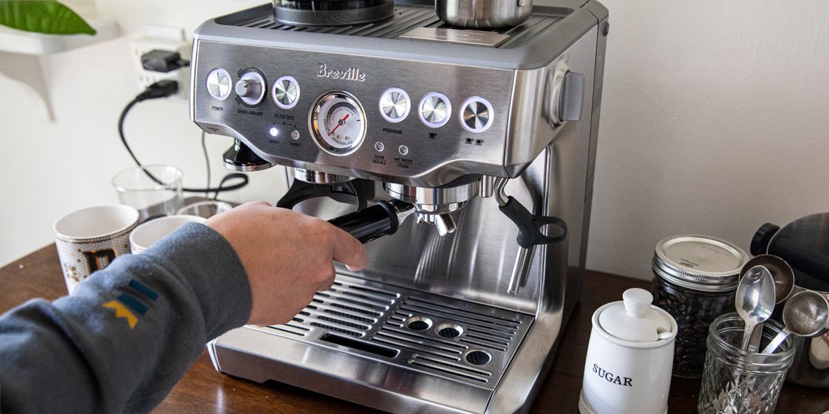 Person using espresso machine