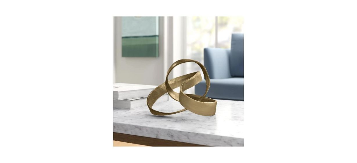 Mercury Row Samara Metal Knot Sculpture on a coffee table