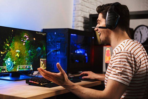 Person playing a video game at a desk