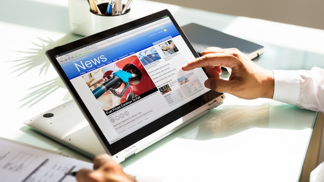 Person looking at 2-in-1 laptop at a desk