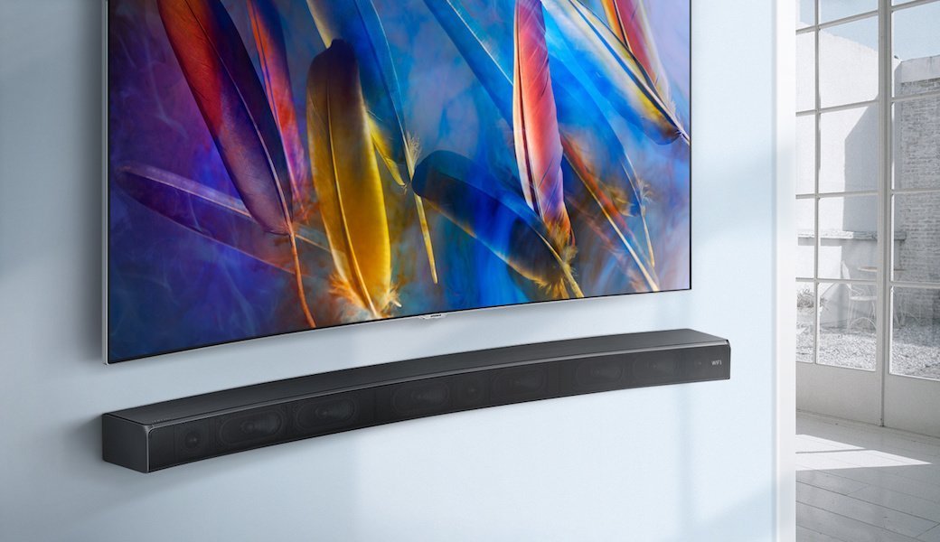 Samsung soundbar under a TV mounted on the wall