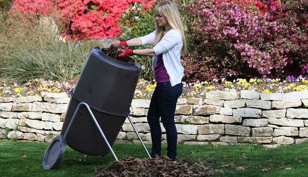 A person using a garden composter