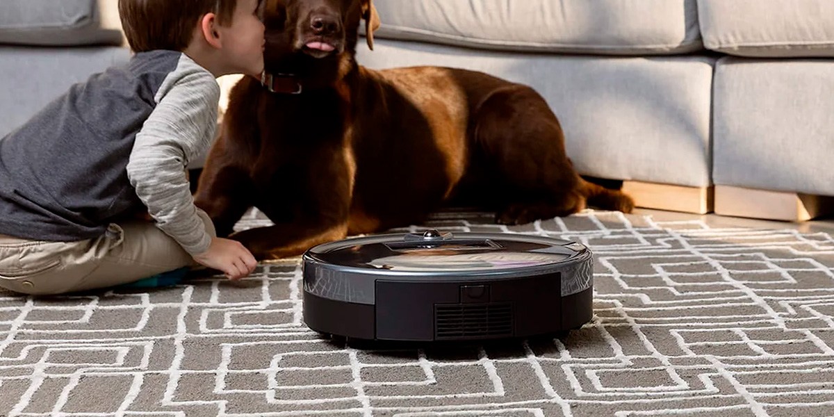 Bobsweep Bob PetHair Plus on carpet next to child and dog