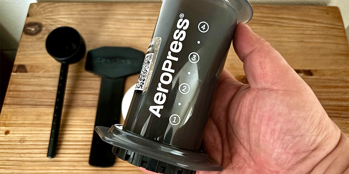 Hand holding AeroPress Original Coffee Press