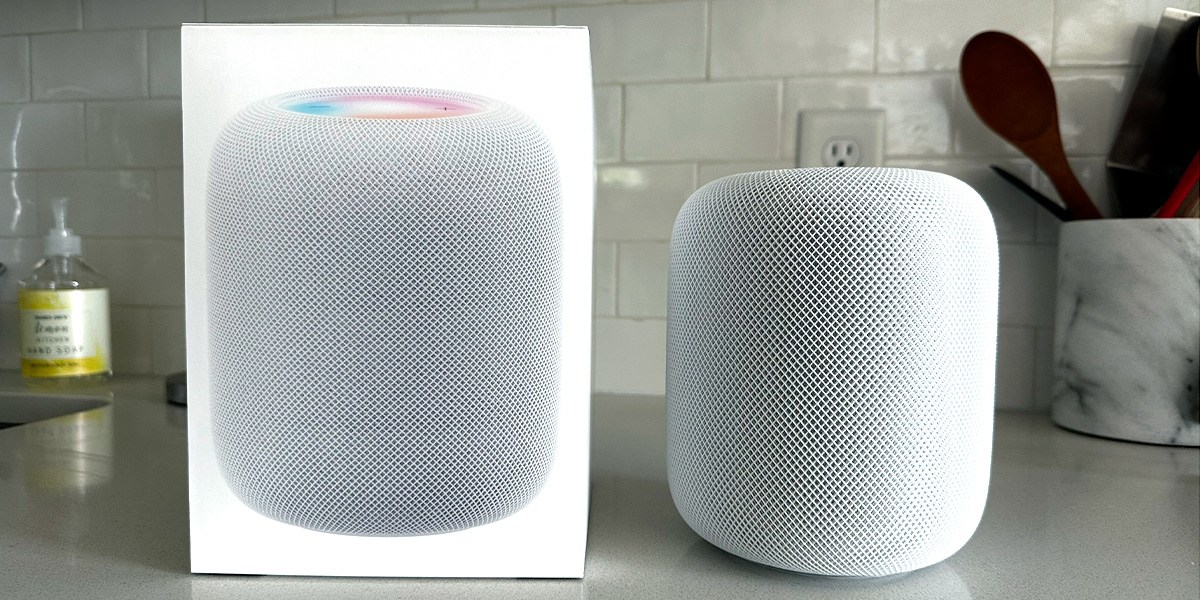 Apple HomePod Mini on counter next to product packaging