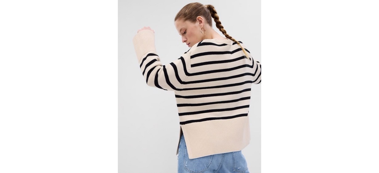 Back view of women wearing split-hem crewneck sweater