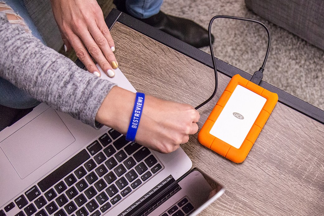 Person hooking external  hard drive to laptop