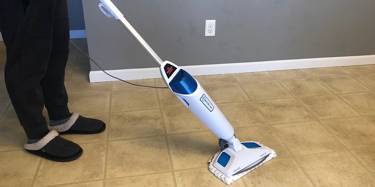 Person using Bissell PowerFresh Steam Mop 1940A on hard floor