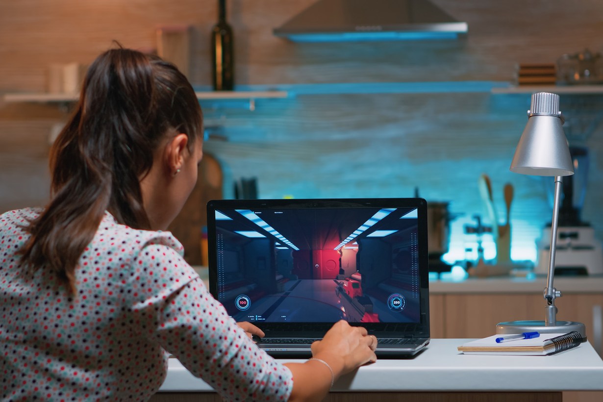Gamer playing a game on a laptop