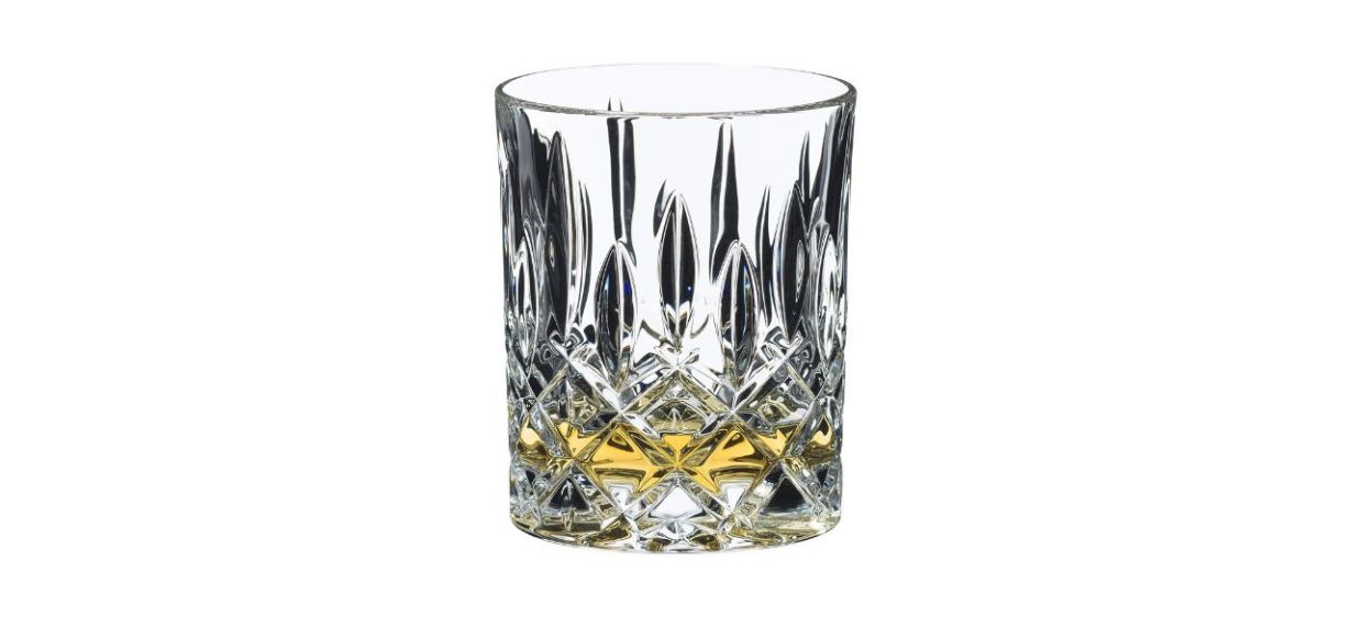 A crystal tumbler with some whiskey in it