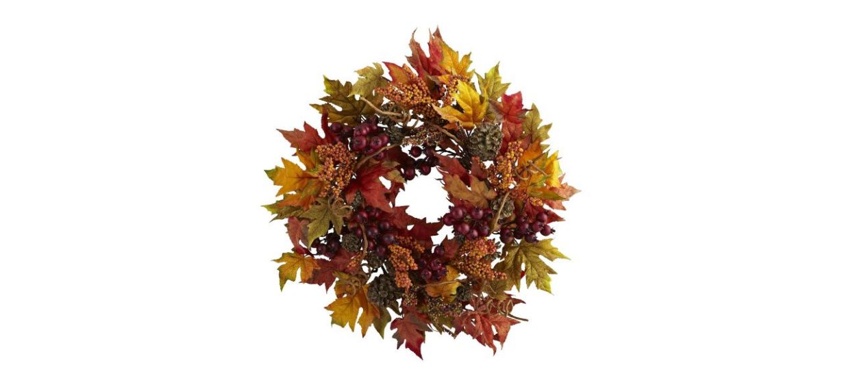 A wreath with artificial maple leaves (yellow and orange), yellow and red berries and tiny pine cones.