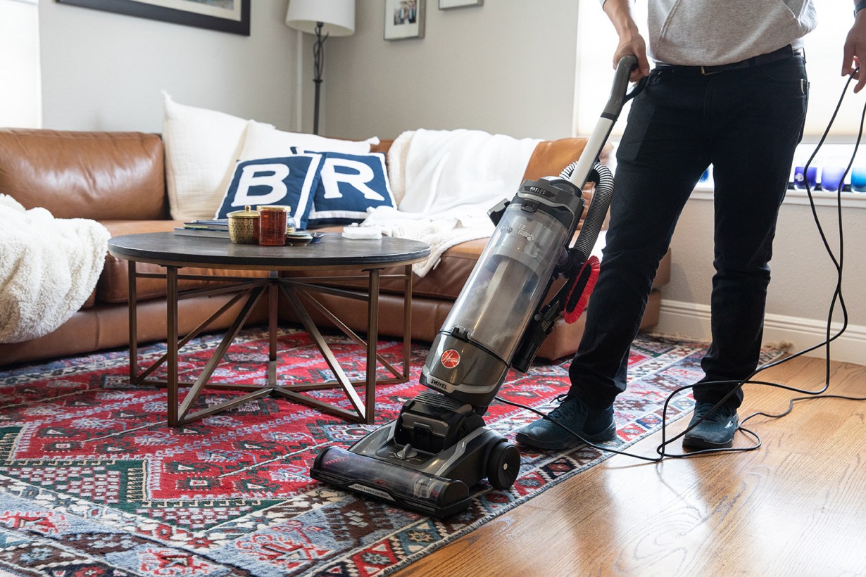 a person using a vacuum cleaner
