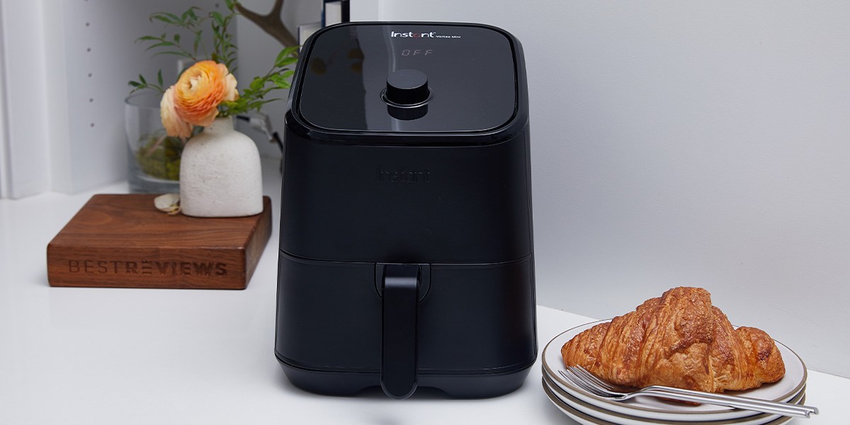 Instant Vortex Mini 2-quart Air Fryer on counter next to plate with croissant