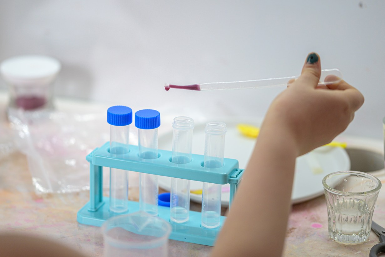 a girl playing with a chemistry kit