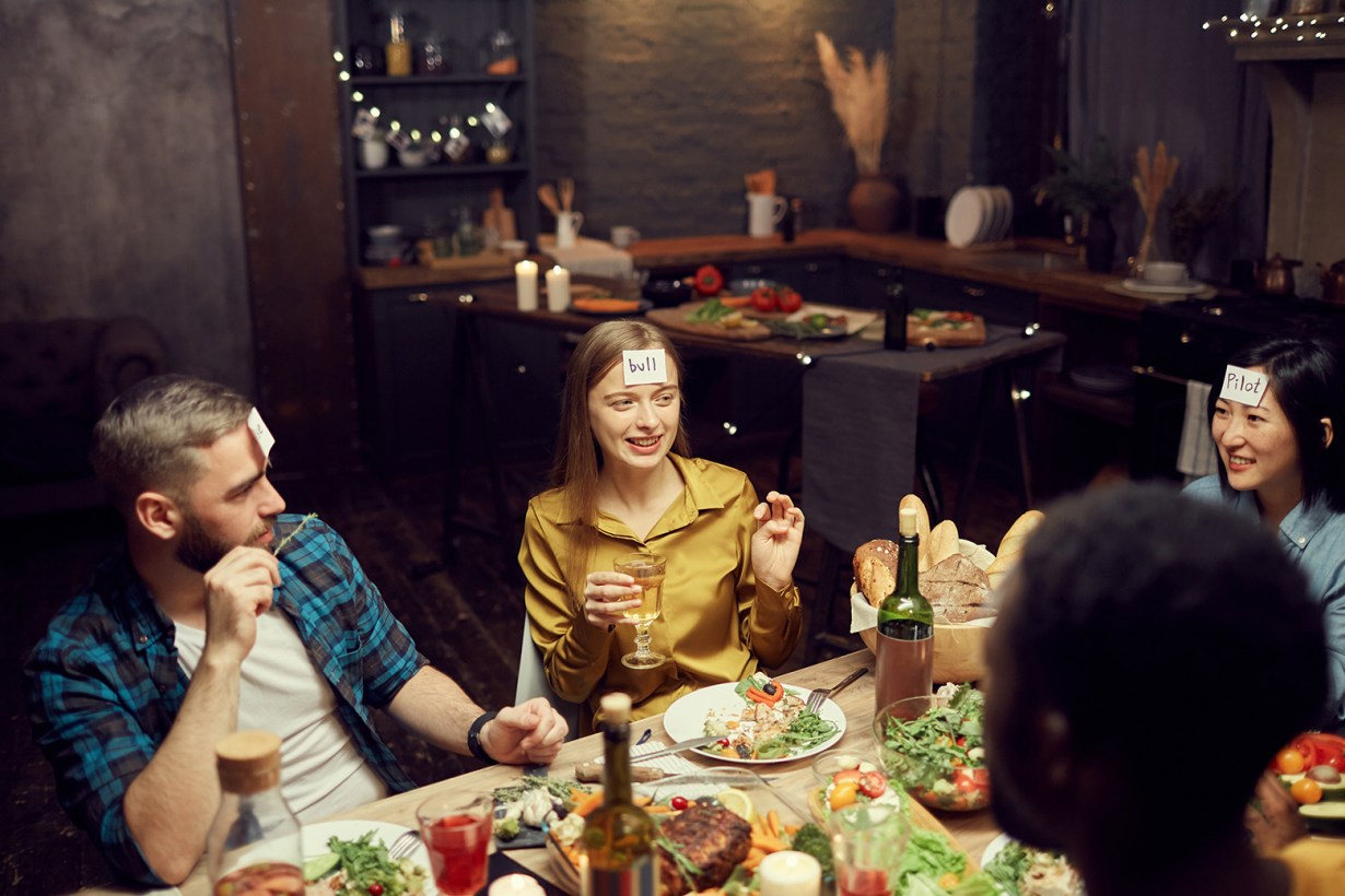a group of friends playing while eating Thanksgiving dinner