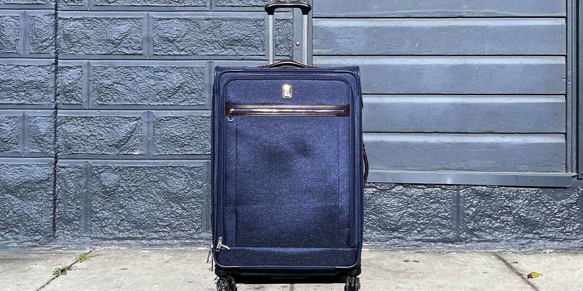 Travelpro Platinum Elite Large Check-In Spinner in front of wall