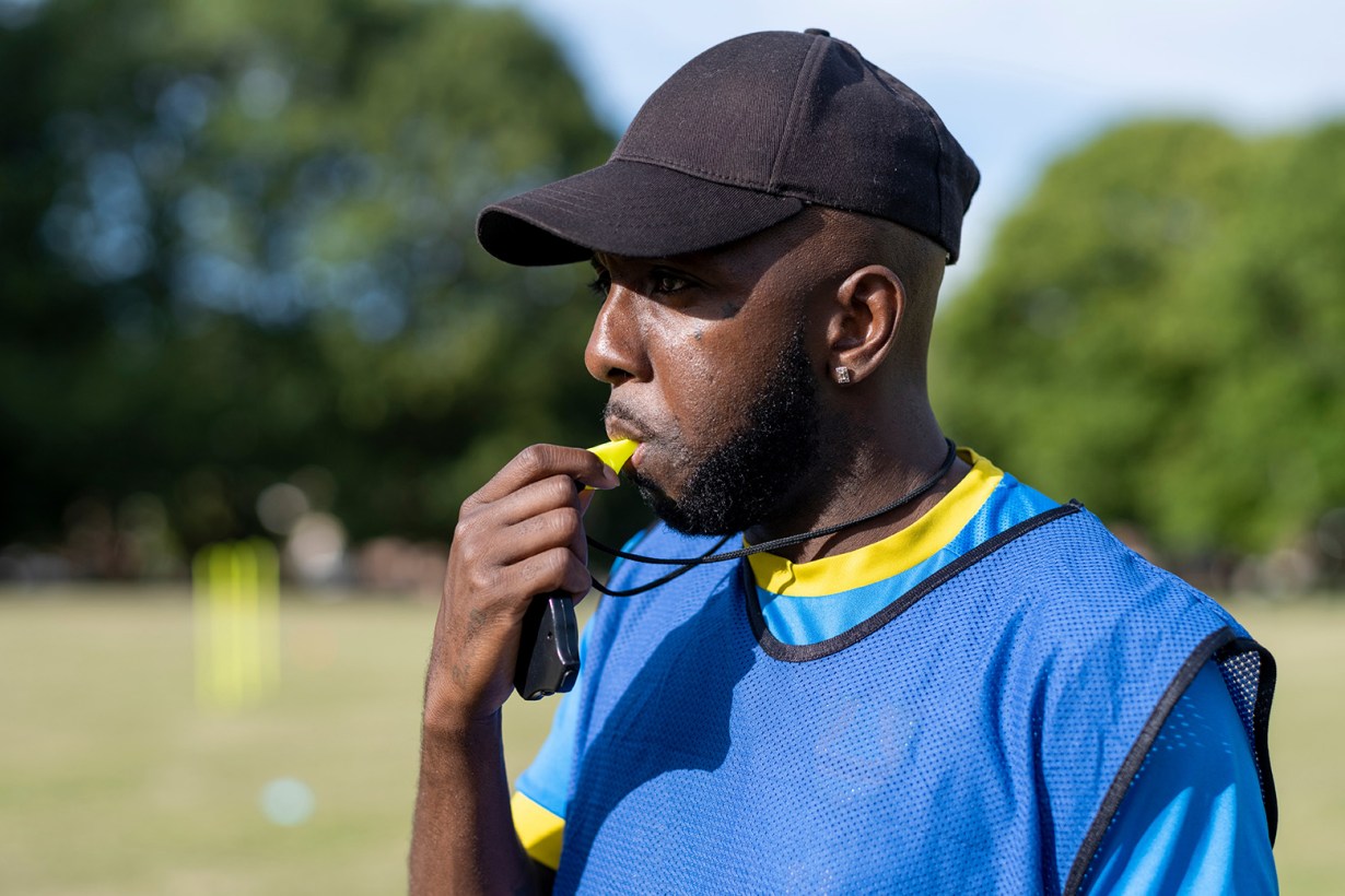 a referee blowing a whistle